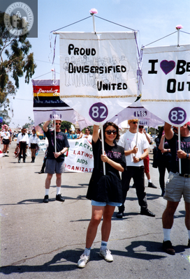 Laura holding Lesbian and Gay Archives banner in Pride parade, 1994