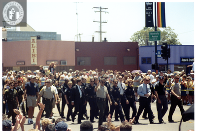 Police officers walking and waving in Pride parade, 1998