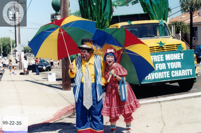 Colorful clowns with rainbow parasols at the Pride parade lineup, 1999
