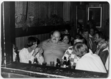 Ray Finch sitting surrounded by friends at his birthday party at Diablo's