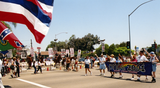 "Pride 2001" banner with protesters in background at Pride parade, 2001