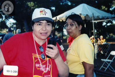 Cheli Mohamed and Robin Wilson hold walkie talkies, 1999