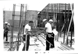 Construction workers assemble reinforcing rods, 1967