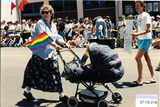 Woman pushing baby carriage at Pride parade, 1997