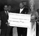 Empress Nicole and Emperor Craig presenting check, 1982