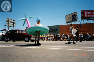 Man marching in an inflatable island in Pride parade, 1999