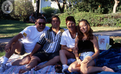 Family on grass at Family Weekend, 2000