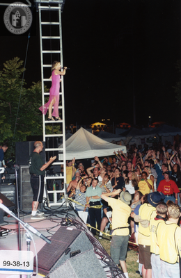 Singer on ladder at Pride Festival, 1999