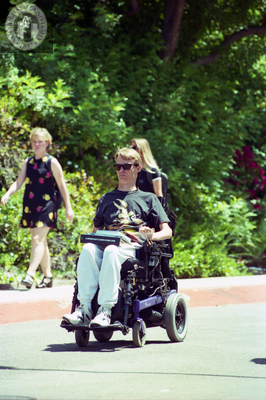 Student in power wheelchair on Hilltop Way, 1996