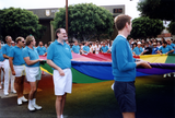 Men carrying the rainbow flag in Pride parade, 1991