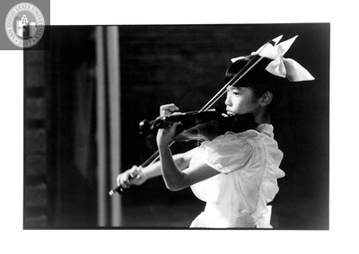Tamaki Kawakubo as a child, playing a violin