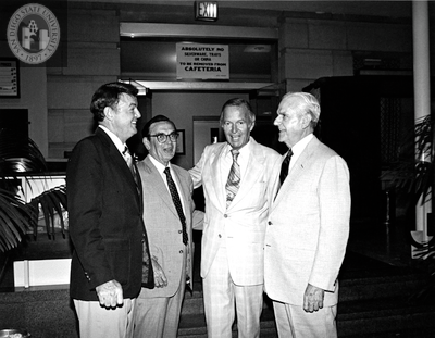 Lionel Van Deerlin with unidentified men outside a cafeteria