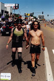 Marchers wearing leather hold hands in the Pride parade, 1999