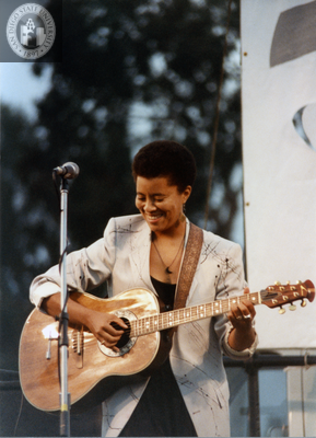 Deidre McCalla playing guitar at San Diego Pride Festival, 1989