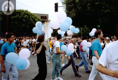 Marchers holding balloons at Pride parade, 1991