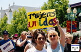 "Mujeres unidas" sign at Dyke March, 2002