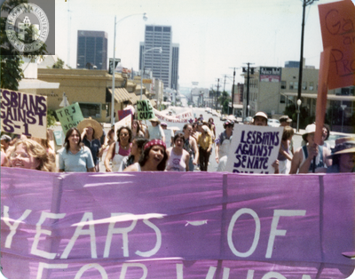 "Lesbians against Senate Bill S-1" behind banner at Pride parade, 1976