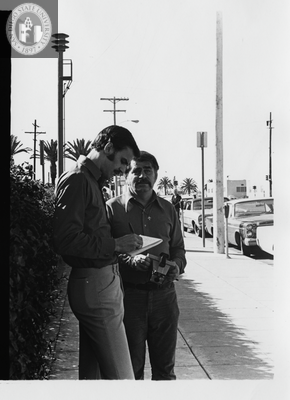 Reporter and photographer during Gay Liberation Front picket, 1971