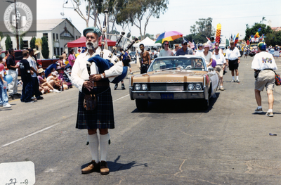 Marcher playing bagpipes in Pride parade, 2000