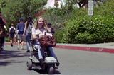 Woman on power mobility scooter, 1996