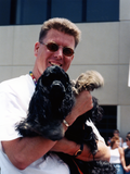 Doug Case holding dog at Pride parade, 1998