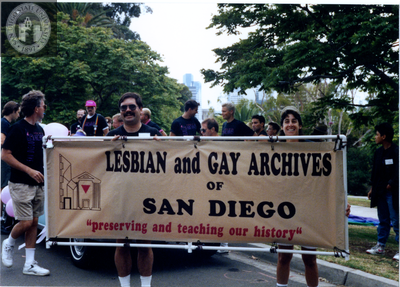James Burnette and Lori Kaye hold banner at Pride parade, 1990