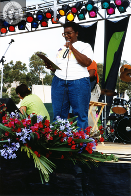 Vertez Burks at microphone on outdoor stage at Pride festival, 1992