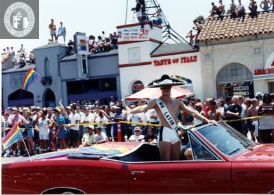 Mr. Latin Lover standing in red convertible in Pride parade, 1996