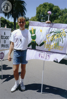 Pride parade marcher holds flag with 1986 Pride theme, 1992