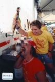 Pride staff goof off for the camera in a beer garden at the festival, 1999