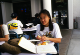Student at table outside West Commons