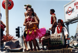 Hula dancer with musicians on Pride parade float, 1996