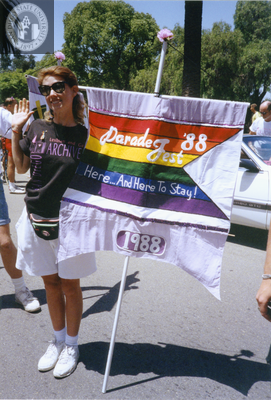 Pride parade marcher holds flag with 1988 Pride theme, 1992