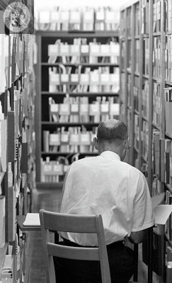 Library worker in government publication stacks