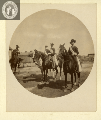 Four uniformed men on horseback