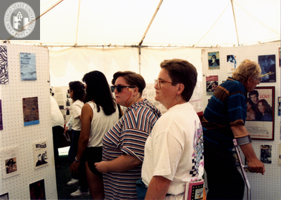 Attendees in LGHSSD booth at Pride festival, 1993