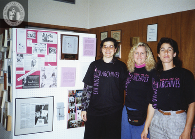 Lambda Archives volunteers in front of display board at Pride festival, 1988