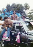 People riding in back of truck in Pride parade, 1988