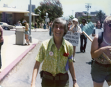 Woman smiling at Pride parade, 1976