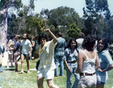 Woman pumping fist in air at Pride festival, 1976