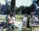 Gathering with "Party Gays" sign at Pride festival, 1976