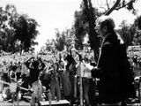 Jess Jessop at microphone at Pride rally, 1977