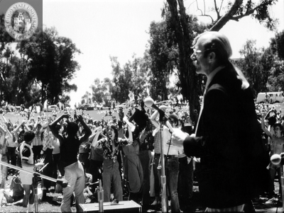 Jess Jessop at microphone at Pride rally, 1977