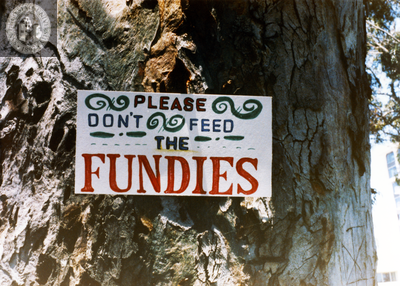 "Please don't feed the fundies" sign posted on tree in Balboa Park, 1985