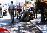 Police officers restraining Brian Barlow at Pride parade, 1986