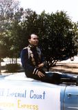 Nicole Murray Ramirez sitting on Imperial court car in Pride parade, 1985