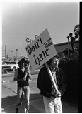 Two men picketing with signs during Gay Liberation Front picket at SDPD, 1971