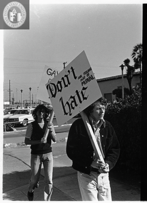 Two men picketing with signs during Gay Liberation Front picket at SDPD, 1971