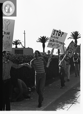 Stephen Bell holds a man's hand, Gay Liberation Front picket at SDPD, 1971