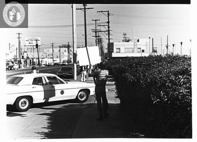 Picketer on street corner during Gay Liberation Front picket at SDPD, 1971